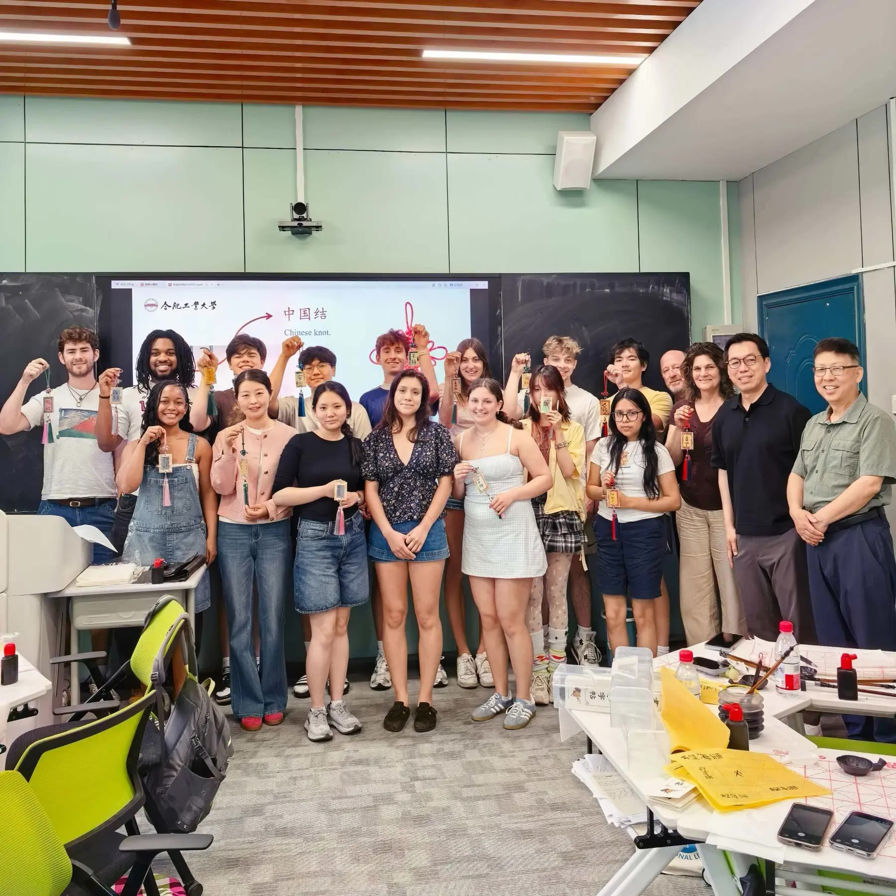 Bucknell and HFUT participants displaying Chinese knots and calligraphy projects